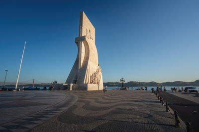 Low angle view of statue against clear blue sky