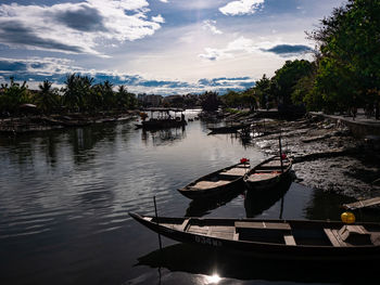 Boat moored in lake against sky