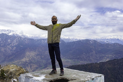 Man enjoying nature and expressing the happiness at kartik swami, uttarakhand