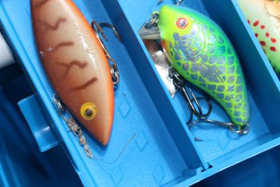 Directly above shot of fishing tackles in blue box