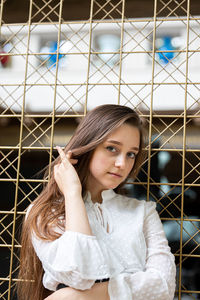 Portrait of young woman looking at camera