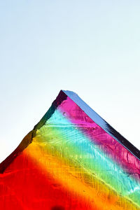 Low angle view of multi colored flag against clear sky