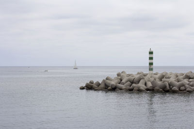 Rocks floating on sea against sky