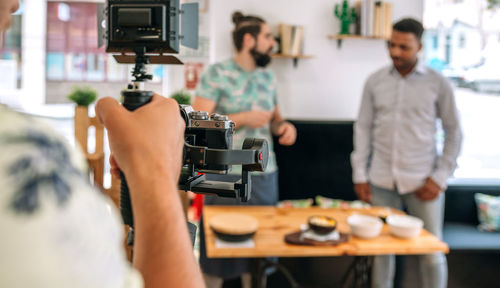 Cameraman recording video of cooking show