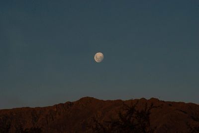 Low angle view of mountains against clear sky at night