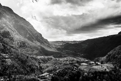 Scenic view of mountains against cloudy sky