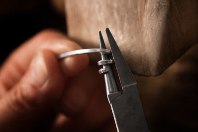 Cropped hand of manual worker working in factory