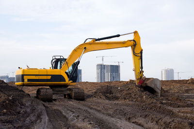 Construction site by road against sky