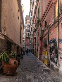 Narrow street amidst buildings in city