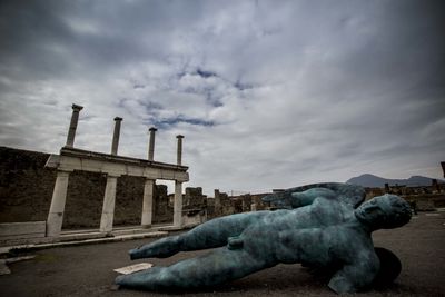 Statue of building against cloudy sky