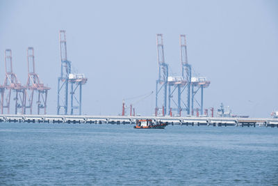 Sailboats in sea against clear sky