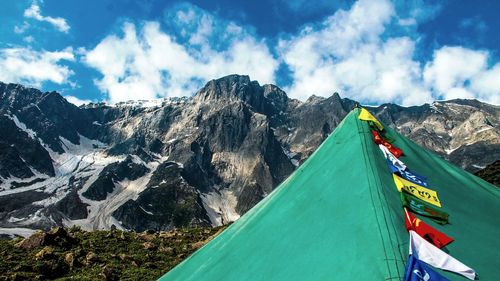 Prayer flags and mountains against sky