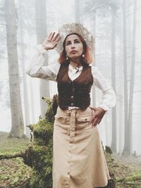 Beautiful woman standing in forest