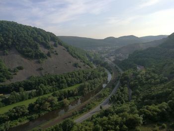High angle view of green landscape against sky