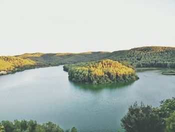 Scenic view of river with trees in background