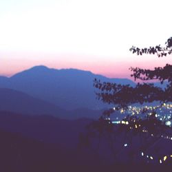 Scenic view of mountains against sky at sunset