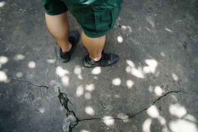 Low section of man standing on street