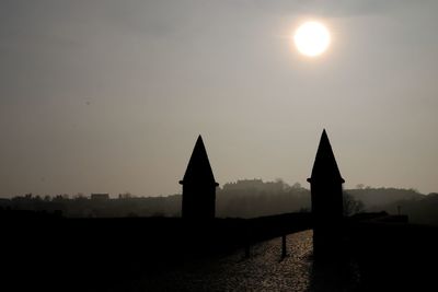 Silhouette built structure against sky during sunset