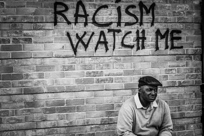 Portrait of man with text on wall