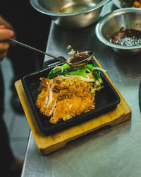 Close-up of hand holding food on table