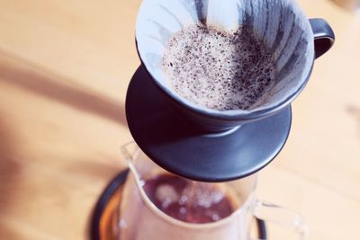 Make drip coffee ,barista pouring water on coffee ground with filter