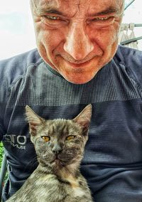 Portrait of a man with cat
