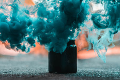 Blue smoke coming out from jar on street