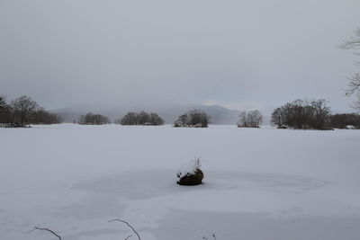 View of snow covered field against sky