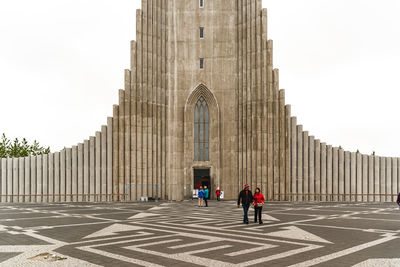 People walking in front of historical building