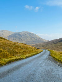 Road amidst mountains against sky