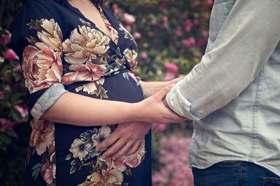 Man touching belly of pregnant woman