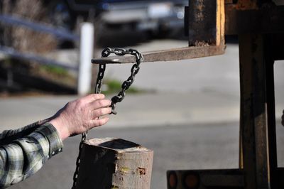 Close-up of hand holding metal