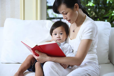 Beautiful woman sitting on book