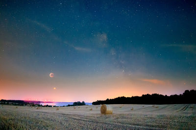 Scenic view of field against sky at night