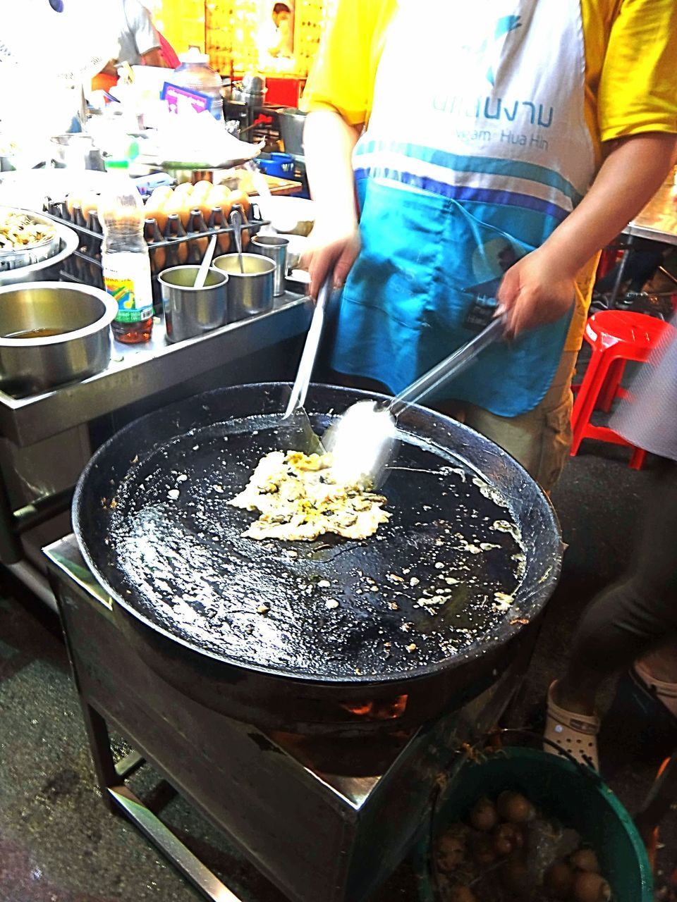 MIDSECTION OF PEOPLE WORKING IN KITCHEN