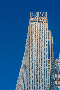 Low angle view of modern building against clear blue sky