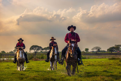 Cowboys riding horses beside the river and lifestyle with natural light background.