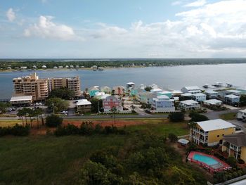 High angle view of townscape by sea against sky