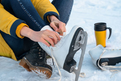 Low section of woman holding snow