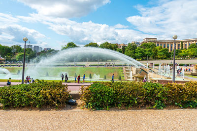 Fountain in park against sky in city