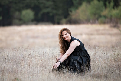 Portrait of smiling young woman on land