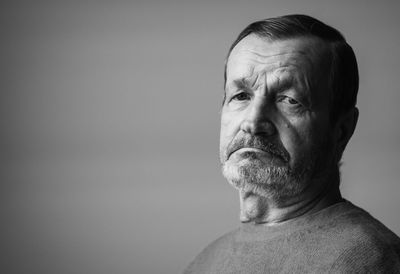 Portrait of depressed senior man wearing sweater