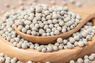 High angle view of white pepper on a wooden spoon
