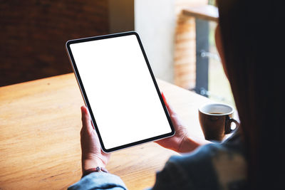 Midsection of woman using digital tablet