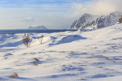 Scenic view of snow covered mountains against sky