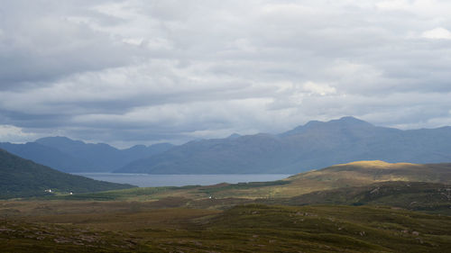 Scenic view of mountains against cloudy sky