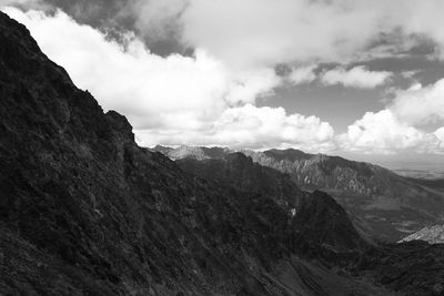 Scenic view of mountains against cloudy sky