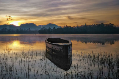 Scenic view of lake against sky during sunset