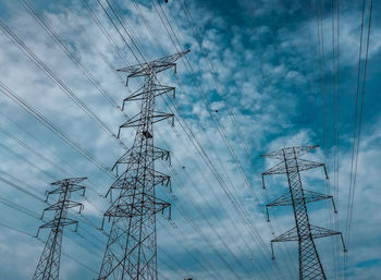 Low angle view of electricity pylon against sky