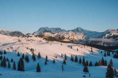 Scenic view of snowcapped mountains against clear blue sky